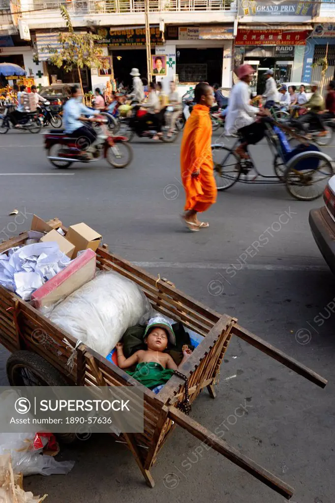 A small child sleeps in a cart on the streets of Phnom Penh, Cambodia, Indochina, Southeast Asia, Asia