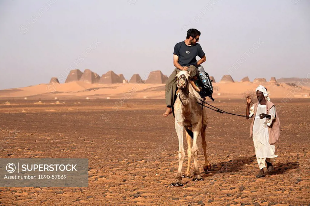 Tourists take camel rides at the pyramids of Meroe, Sudan´s most popular tourist attraction, Bagrawiyah, Sudan, Africa