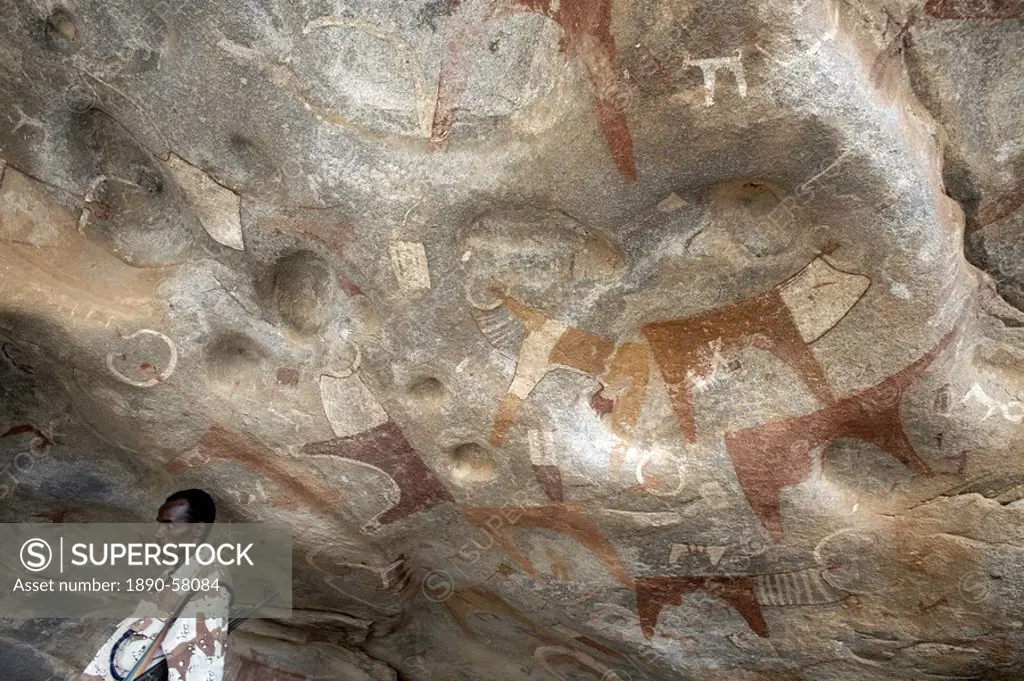 A Somaliland soldier stands guard at the 5000 year_old cave paintings in Lass Geel caves, Somaliland, northern Somalia, Africa