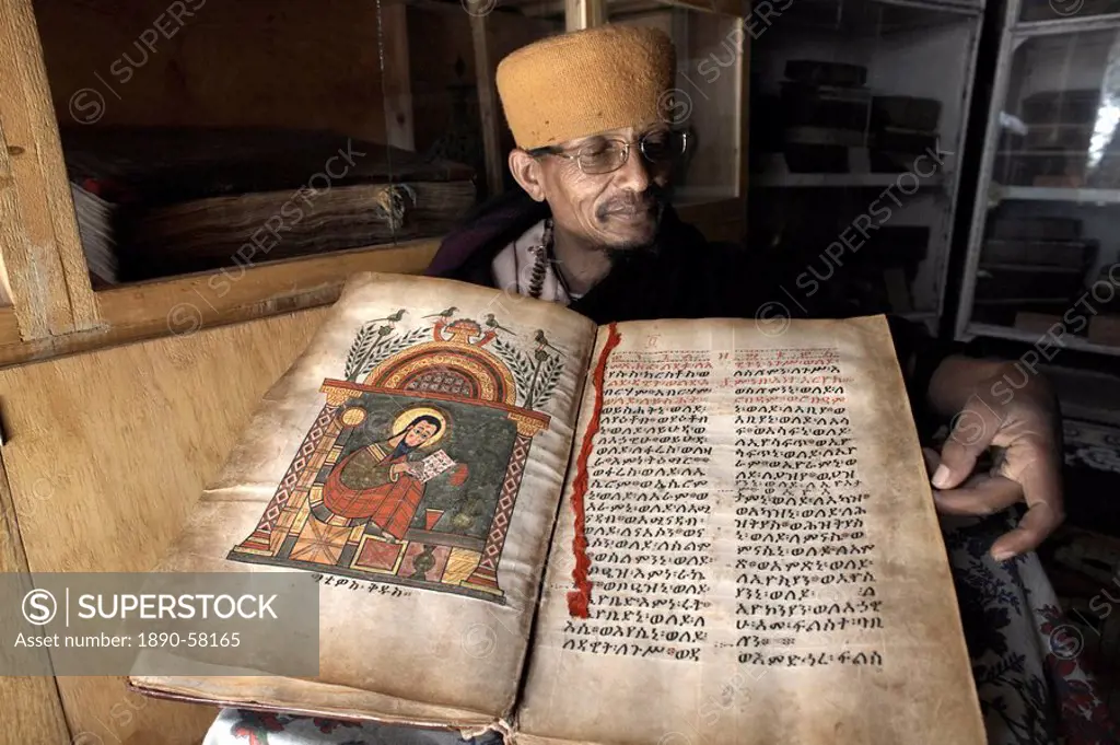 A priest goes through an ancient manuscript at the monastery of Kebran Gabriel, on an island on Lake Tana, Ethiopia, Africa