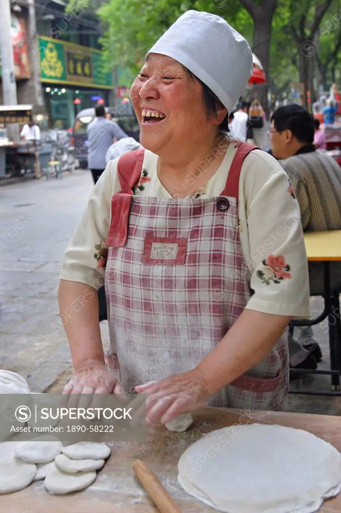 Woman making bread in the Muslim quarter of Xi´an, China, Asia