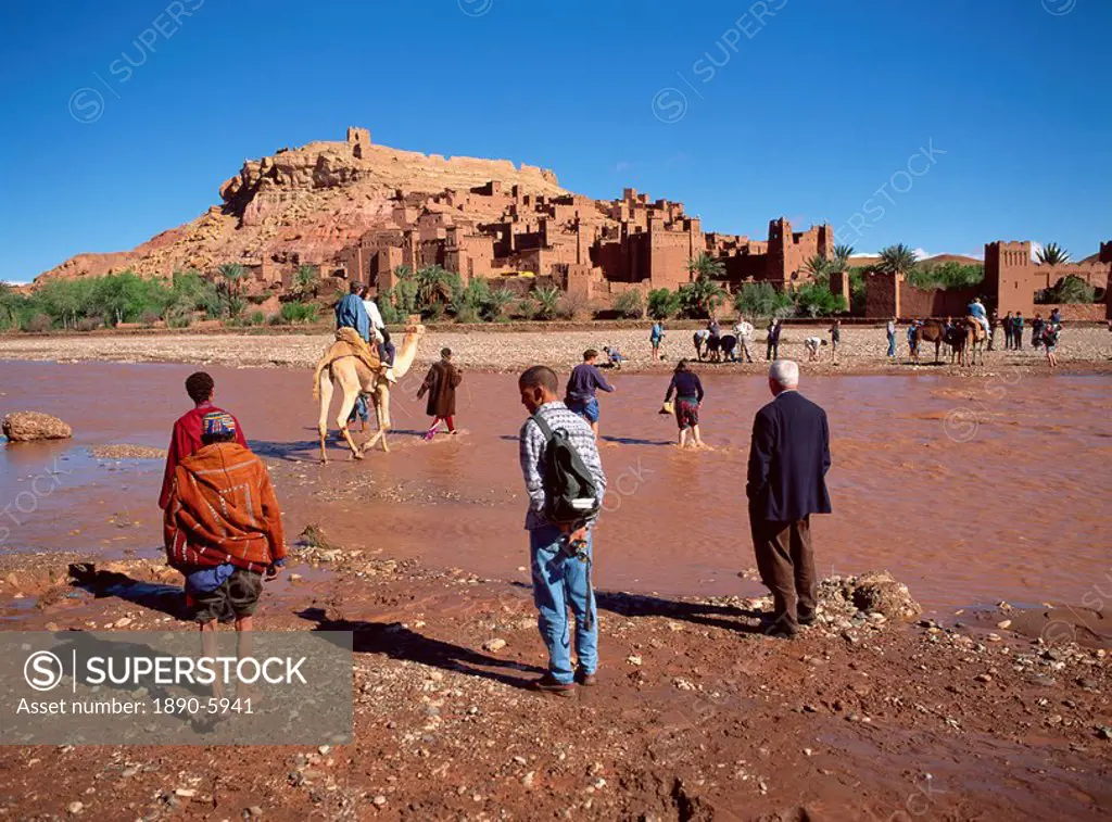 Tourists cross river Asif Mellah to visit Kasbah Ait Ben Haddou, UNESCO World Heritage Site, near Ouarzazate, Morocco, North Africa, Africa