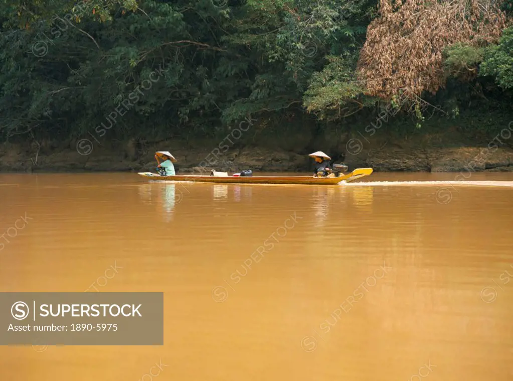 Travel by outboard powered local longboat, Katibas River, Sarawak, island of Borneo, Malaysia, Southeast Asia, Asia