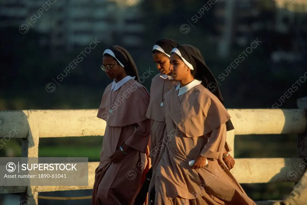 Nuns crossing the Mula River, Pune, Maharashtra state, India, Asia