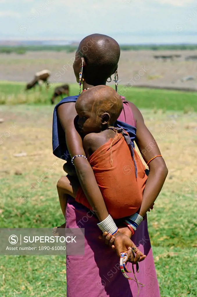 Teenage Masai mother carrying her child in a sling, Tanzania, East Africa, Africa