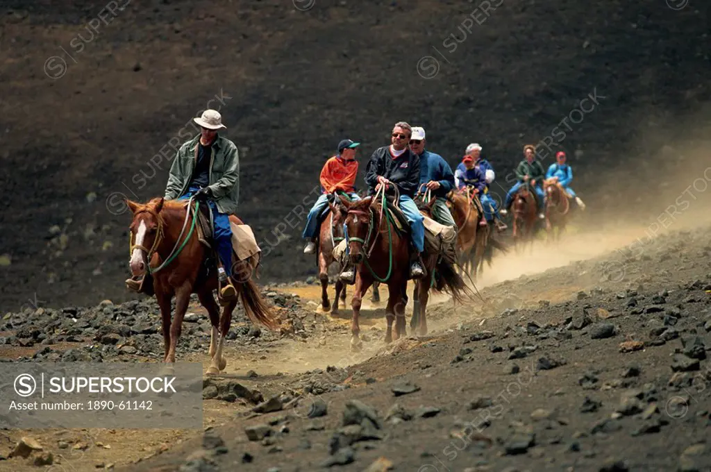 Tourists on horseback riding on crater, Sliding Sands Trail, Haleakala National Park, Maui, Hawaii, Hawaiian Islands, United States of America, North ...