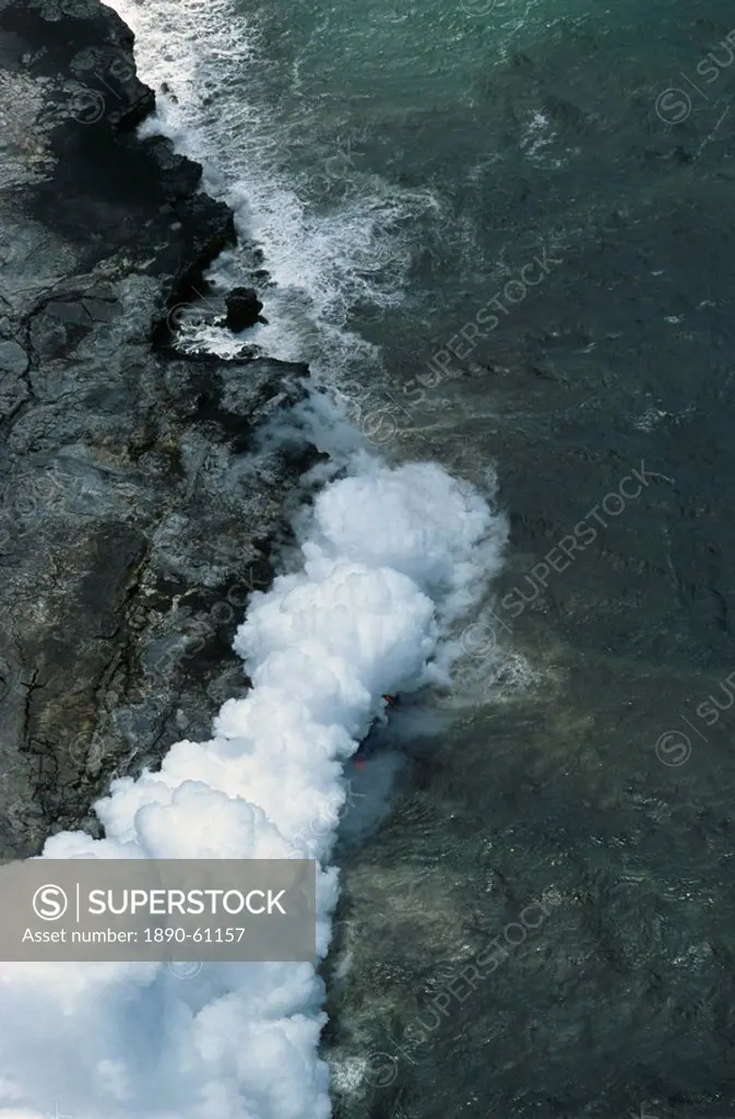 Steam cloud rising where lava from the Pu´u O´o cinder cone far inland enters sea on southeast Puna coast near Kaimu, Big Island, Hawaii, Hawaiian Isl...