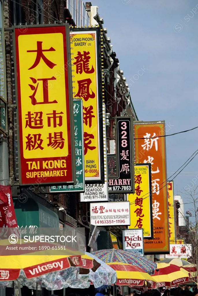 Bi_lingual Chinese and English signs on Spadina Avenue in Chinatown in downtown Toronto, Ontario, Canada, North America