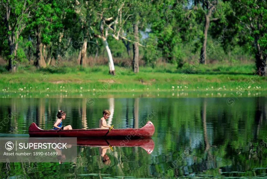 Children canoeing in Annaburroo Billabong at Mary River Crossing near the Arnhem Highway, at the Top End, Northern Territory, Australia, Pacific