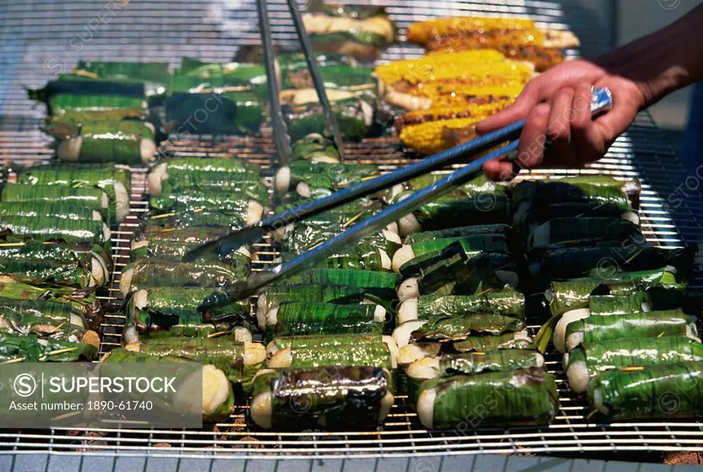 Sticky rice wrapped in banana leaves on barbecue at Vietnamese Lunar New Year Festival in Footscray, a suburb of Melbourne, Victoria, Australia, Pacif...