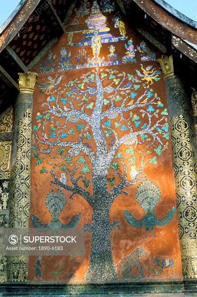 Glass mosaic of tree of life on wall of the 16th century Sim, Wat Xiang Thong, Luang Prabang, UNESCO World Heritage Site, Laos, Indochina, Southeast A...