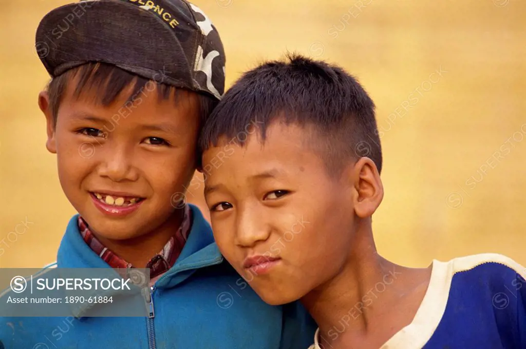 Portrait of two boys of the Akha hill tribe in western dress in the Golden Triangle, Thailand, Southeast Asia, Asia