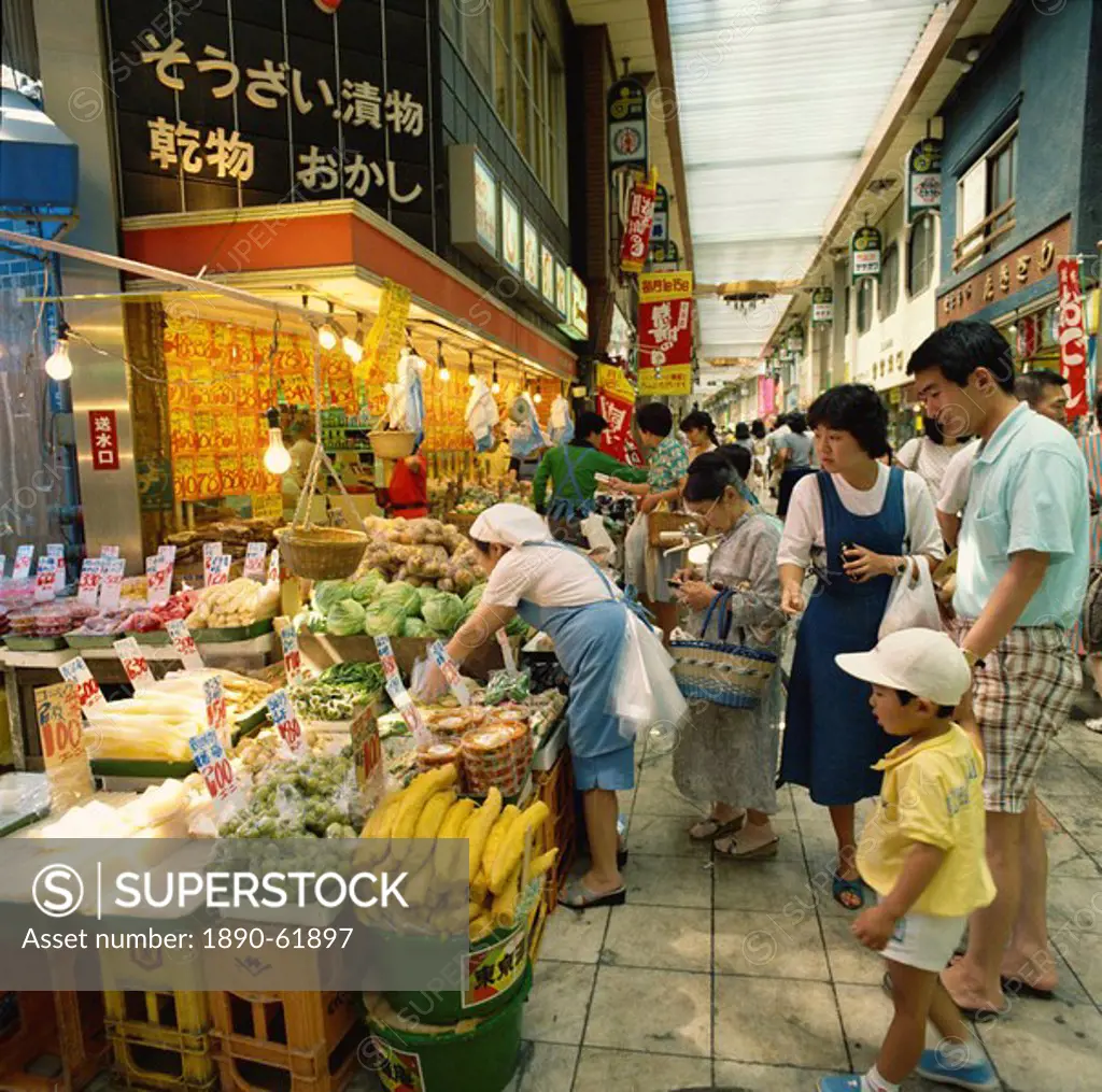 Family shopping in a covered market in Tokyo, Honshu, Japan, Asia