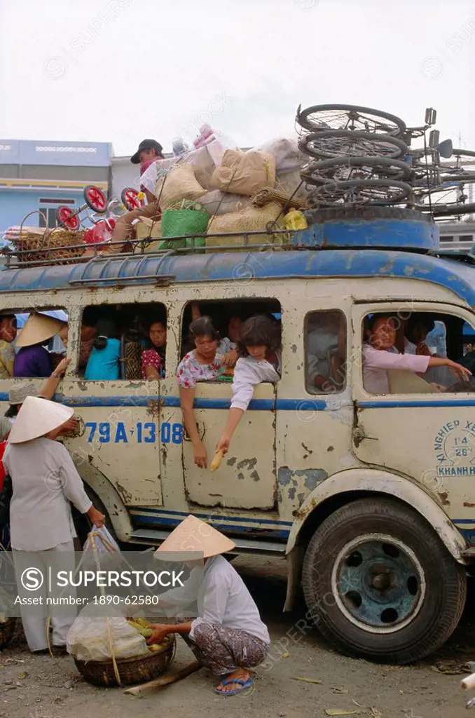 Crowded bus with bicycles, sacks and passengers on roof, city bus terminal, Nha Trang, Vietnam, Indochina, Southeast Asia, Asia