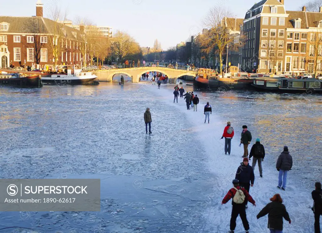 Skaters and walkers on frozen Amstel River,Amsterdam, Netherlands