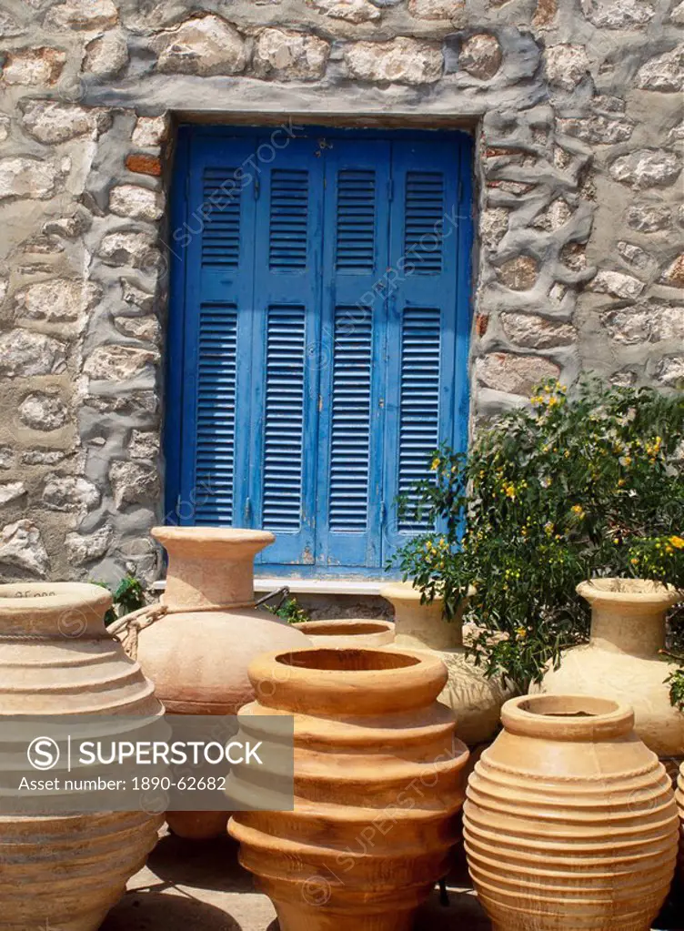 Greek urns in front of a blue door on Hydra, Argo Saronic Islands, Greece