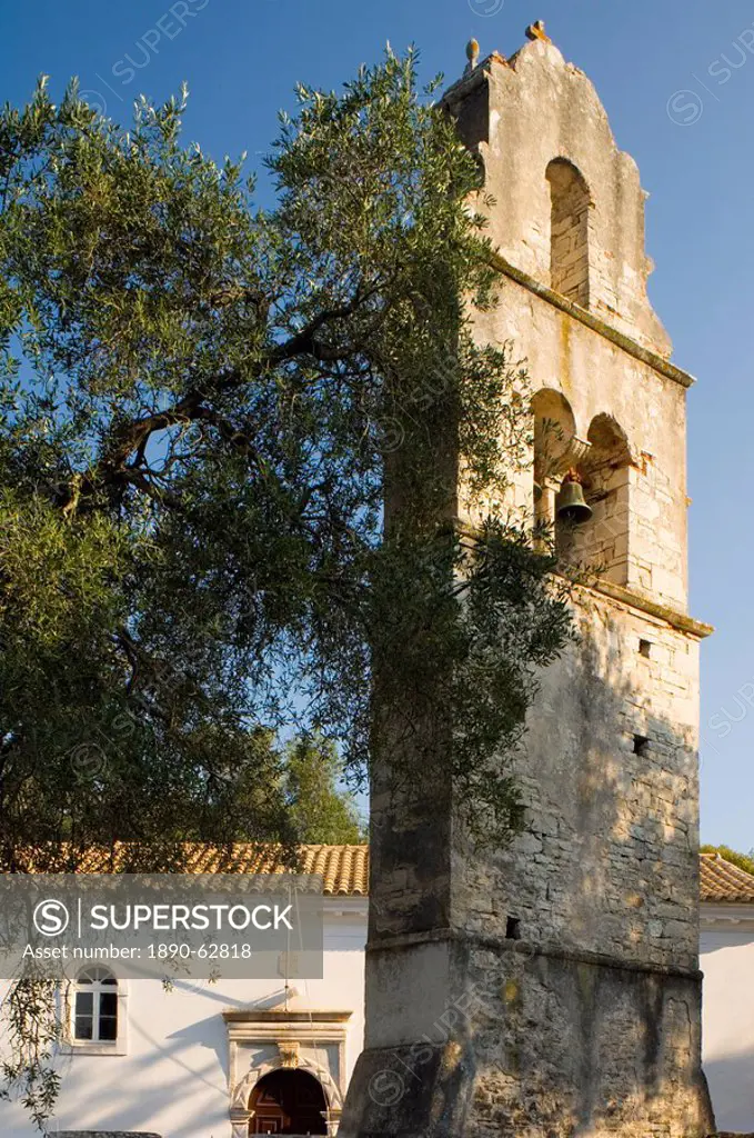 The stone belltower of Agios Constantinos in an olive tree grove, Paxos, Ionian Islands, Greek Islands, Greece, Europe