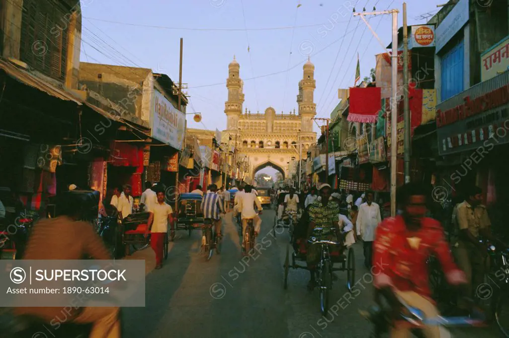Street scene with bicycles and rickshaw and the Char Minar Charminar triumphal arch built in 1591, Hyderabad, Andhra Pradesh State, India