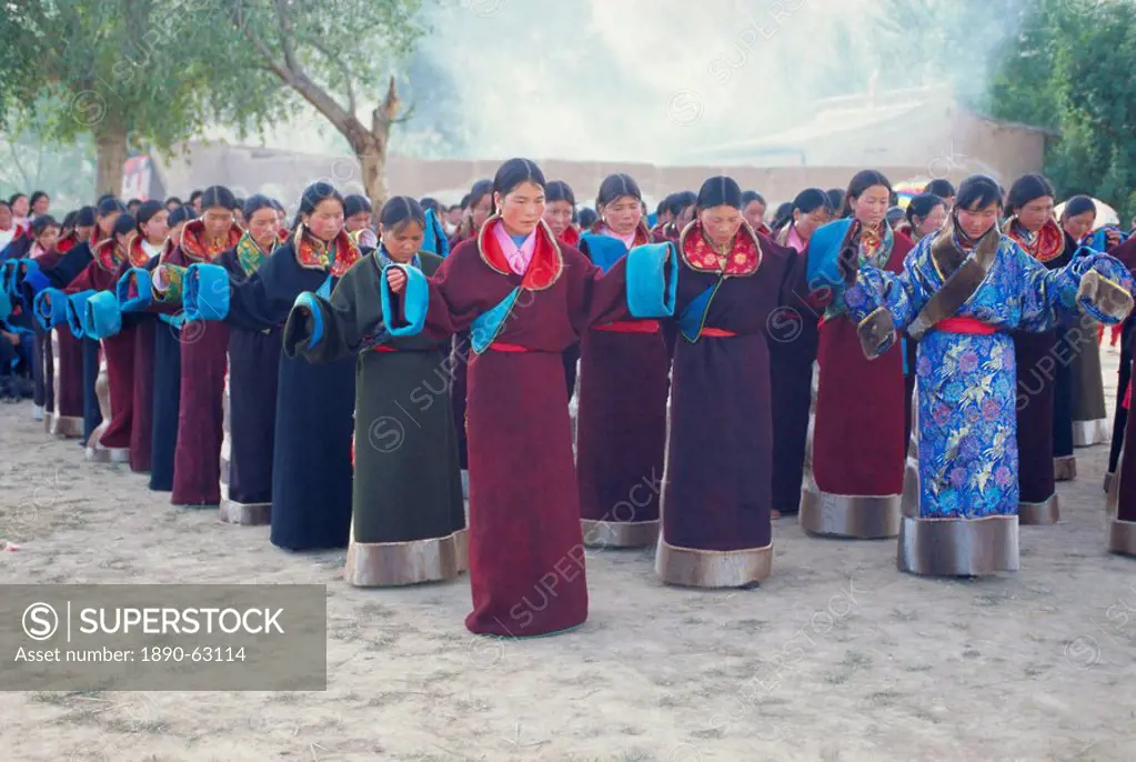 Tibetan women pray at Harvest Festival, Tongren Area, Qinghai Province, China