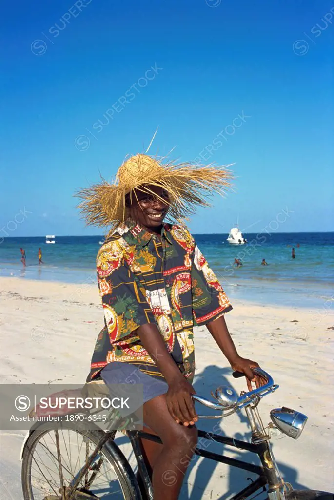 Cyclist with red snapper fish, Nyali Beach, Kenya, East Africa, Africa