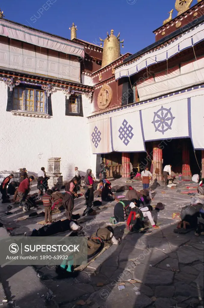 Pilgrims prostrating outside the Jokhang Temple, Lhasa, Tibet, China, Asia