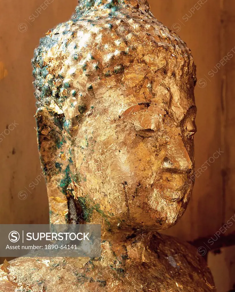 Close_up of the head of a statue of the Buddha covered in gold leaf, Wat Pho Wat Po Wat Chetuphon, Bangkok, Thailand, Southeast Asia, Asia