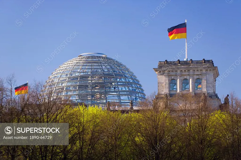 Reichstag German Parliament building, glass dome on top and German flags, Berlin, Germany, Europe