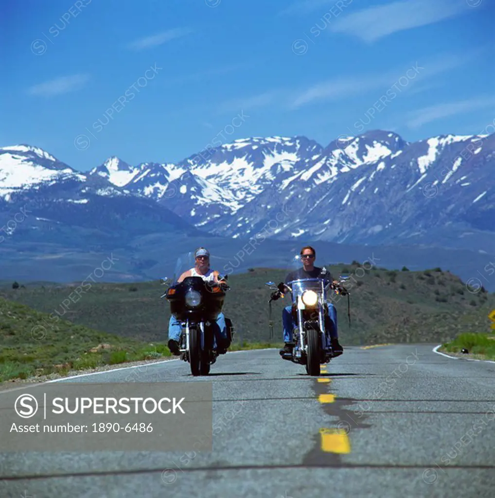 Harley Davidson bikers with snow_capped mountains in background, United States of America, North America