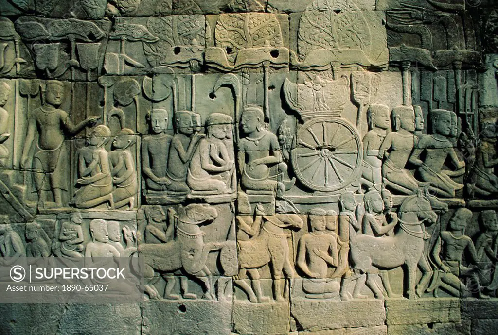 Stone bas_reliefs depicting scenes of rural life and historical events, in the Bayon Temple complex, Angkor, Siem Reap, Cambodia