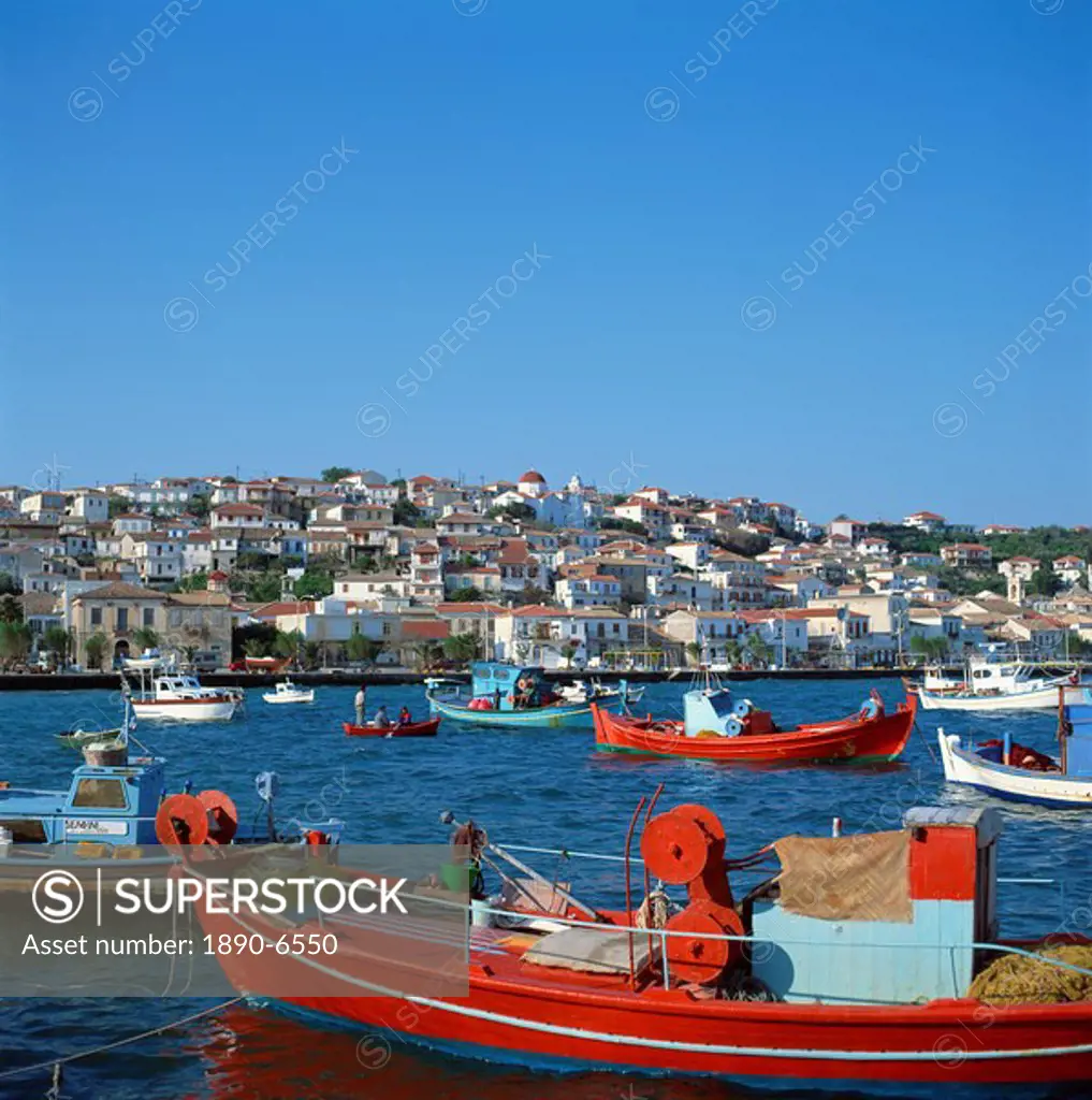 Red and blue painted fishing boats in the harbour in the seaside market and port town of Neapoli, Peloponnese, Greece, Europe