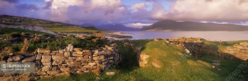 View towards Isle of Lewis from ruins of Blackhouses, Paible, Taransay, Outer Hebrides, Scotland, United Kingdom, Europe