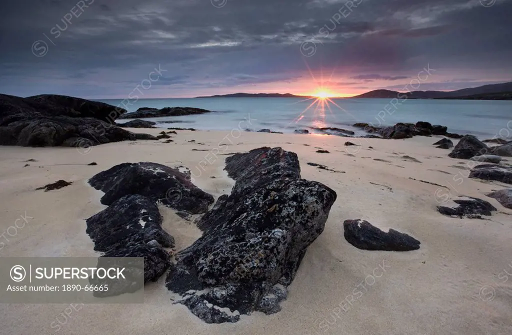 View towards Taransay at sunset from the rocky shore at Scarista, Isle of Harris, Outer Hebrides, Scotland, United Kingdom, Europe