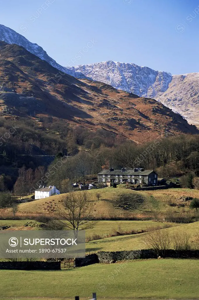 View across fields to cottages and snow_capped mountains, Little Langdale, Lake District National Park, Cumbria, England, United Kingdom U.K., Europe