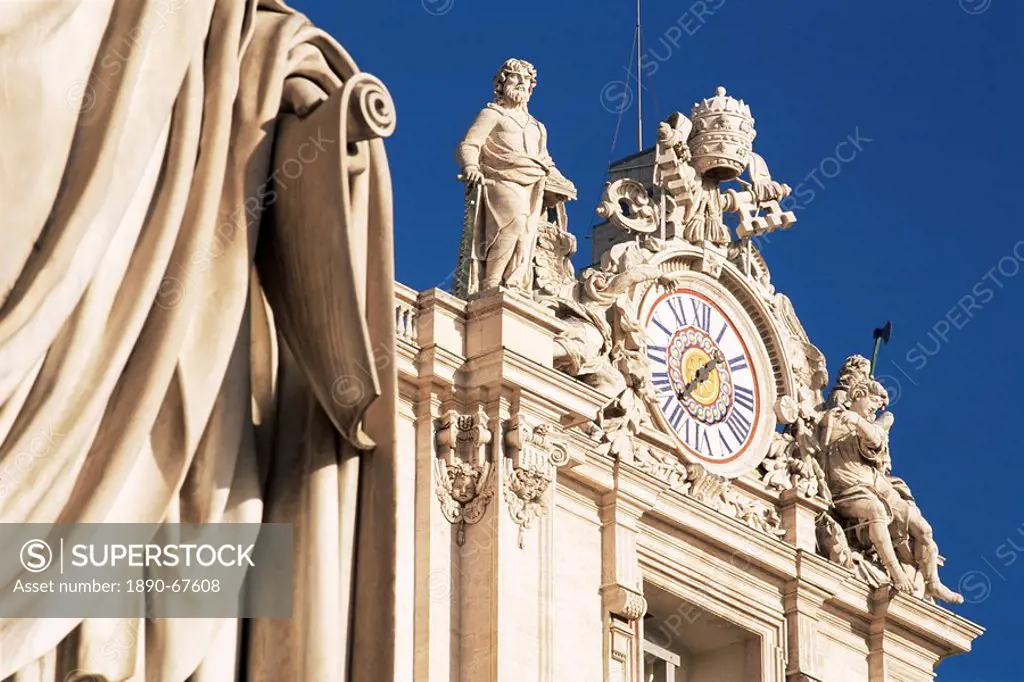 Clock adorning facade of St. Peter´s Basilica, with statue of St. Peter in front, Piazza San Pietro, St. Peters, Vatican City, Rome, Lazio, Italy, Eur...