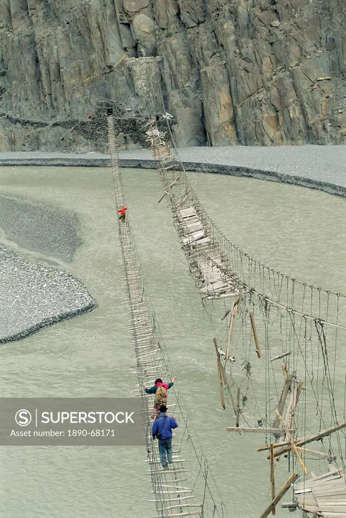 Swinging bridges over river, Bojal, near Passu, Pakistan, Asia