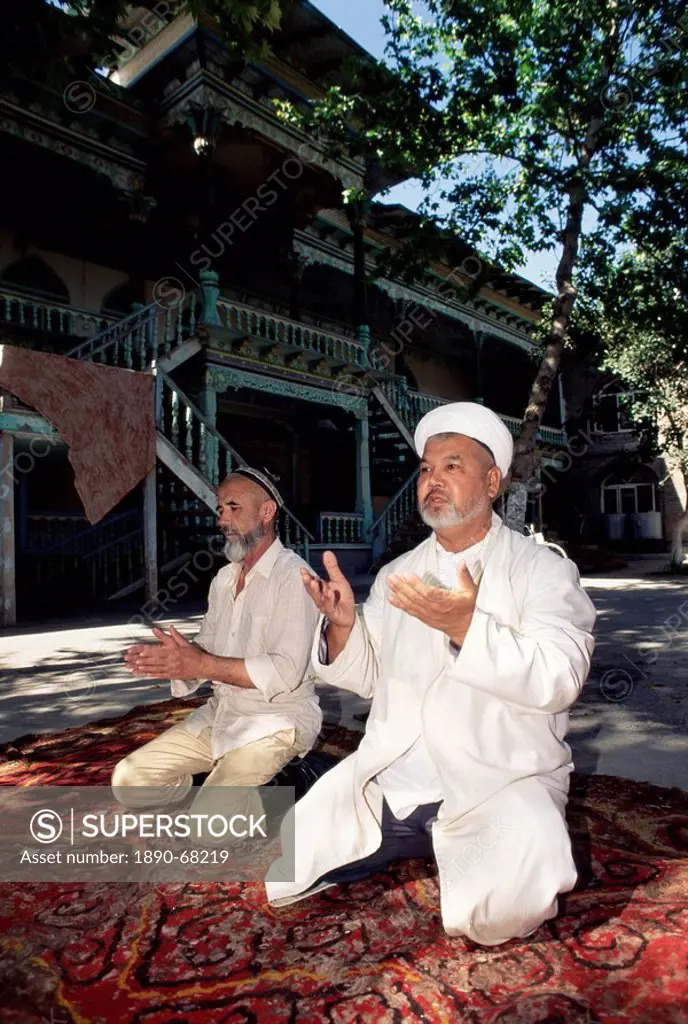 Imam and assistant praying, Central Mosque, Margilan, Uzbekistan, Central Asia, Asia