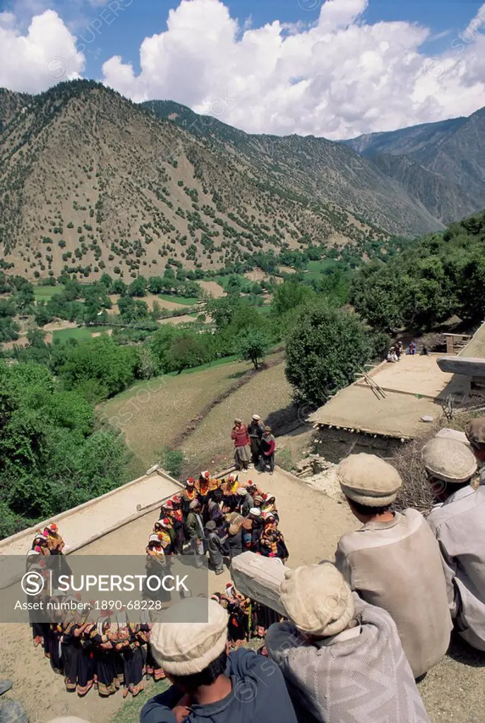 Men watching Kalash women dancing, Spring Festival, Joshi, Bumburet Valley, Pakistan, Asia