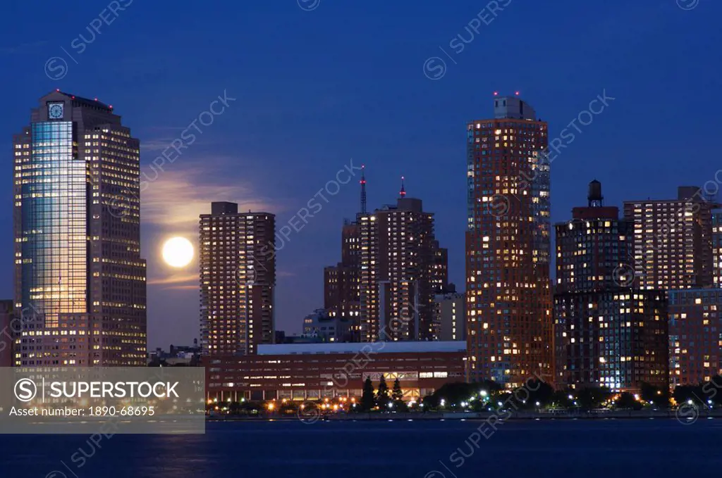 Full moon rising over Lower Manhattan skyline across the Hudson River, New York City, New York, United States of America, North America
