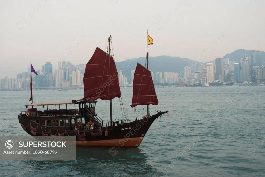 A junk style tourist boat sailing in Victoria Harbour, Hong Kong, China, Asia