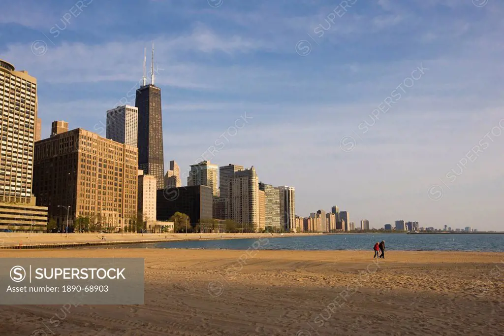 Walkers on Ohio Street Beach with city skyline behind, Chicago, Illinois, United States of America, North America