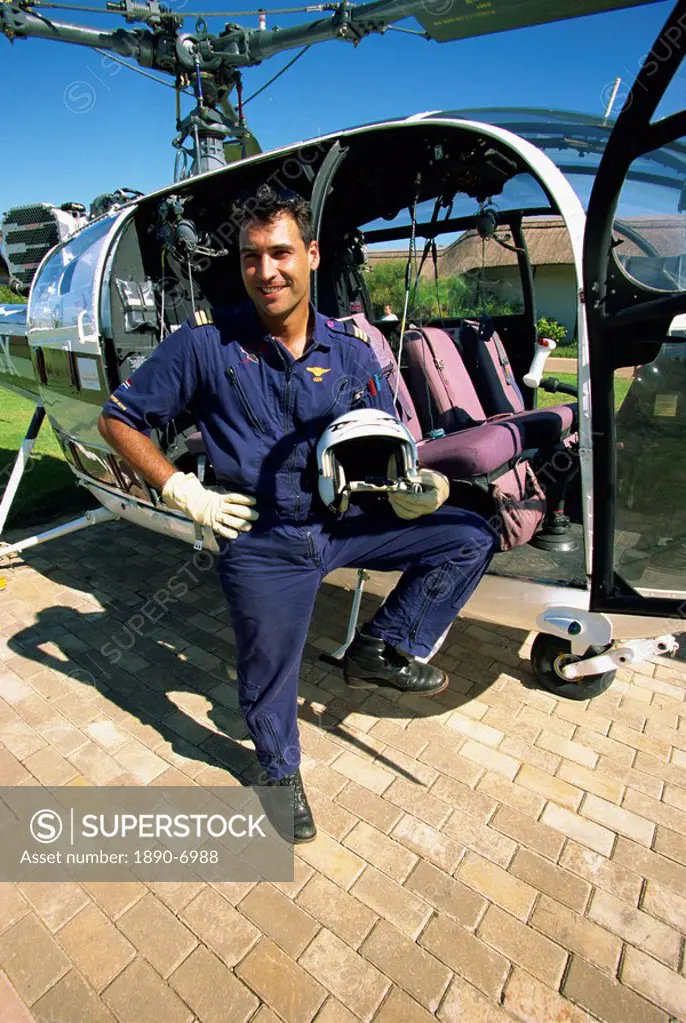 A pilot with his helicopter in Wonder Valley, Central Drakensberg, South Africa, Africa