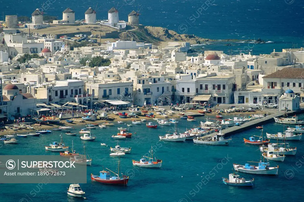 Aerial of the harbour and Mykonos town with windmills in the background, Mykonos, Cyclades Islands, Greece