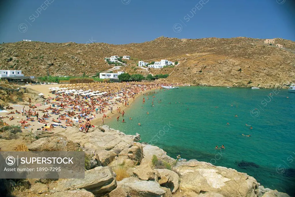 Tourists on the Super Paradise beach with small houses in the background, on Mykonos, Cyclades Islands, Greek Islands, Greece, Europe