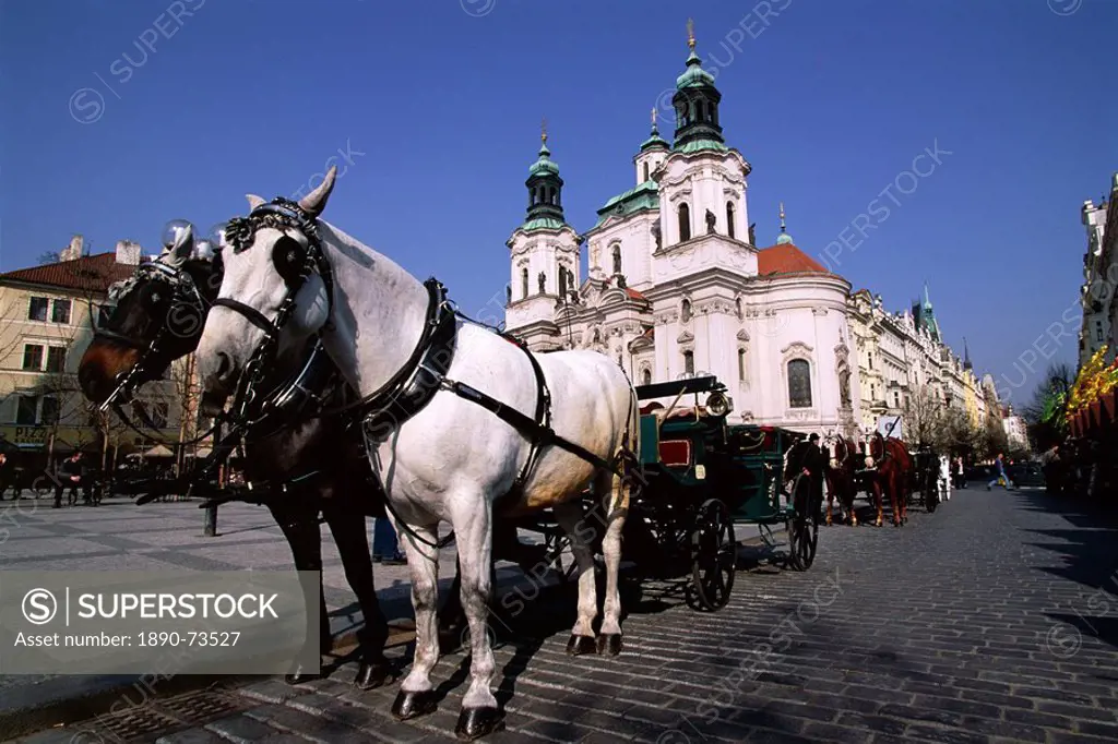 Horse and carriage and church of St. Nicholas, Old Town Square, Prague, Czech Republic, Europe