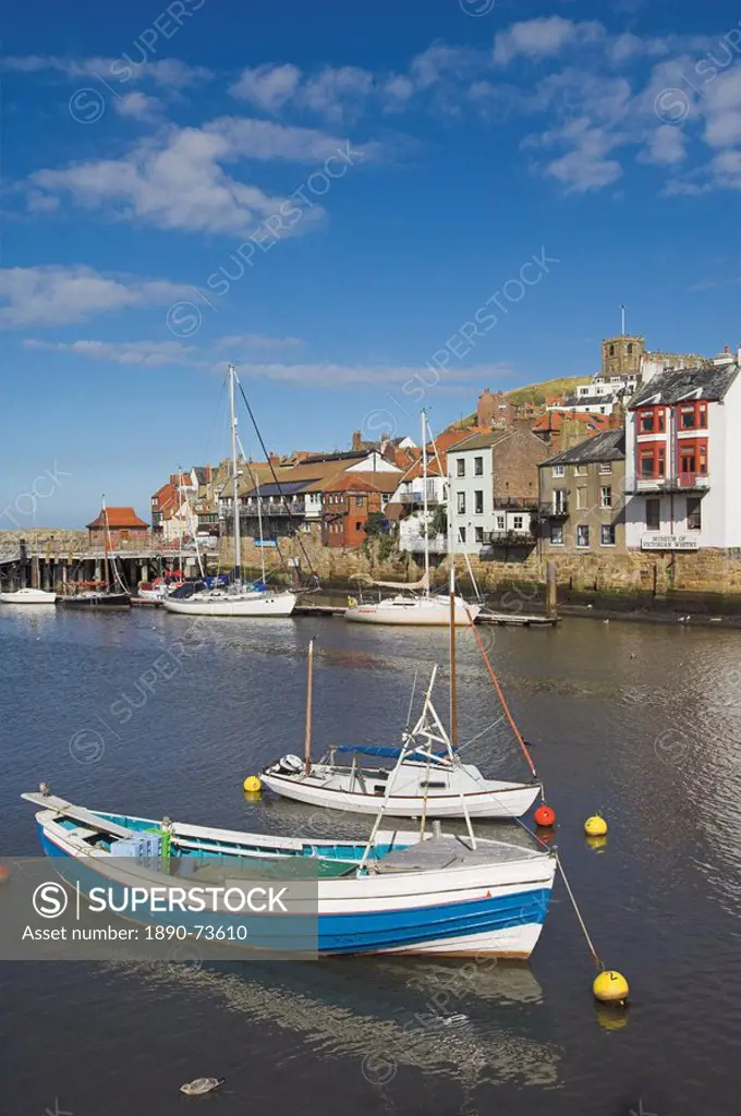 Whitby church and fishing boats in the harbour, Whitby, North Yorkshire, Yorkshire, England, United Kingdom, Europe