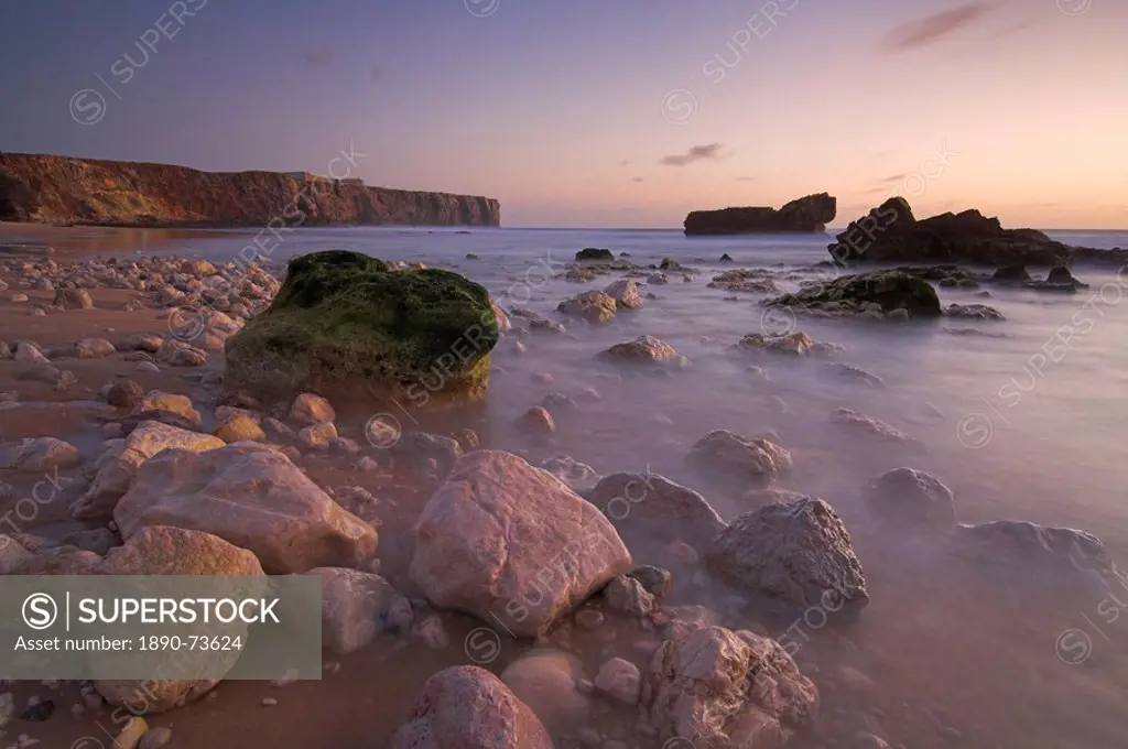 Long exposure of incoming tide on Tonal beach at sunset near Sagres, Algarve, Portugal, Europe