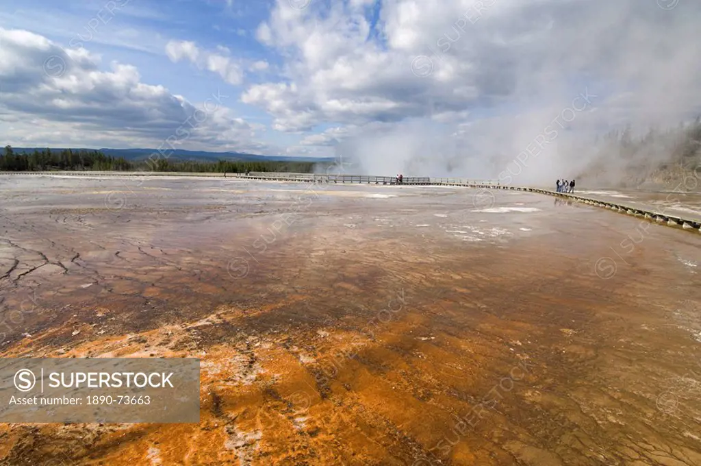 Tourists on boardwalk over the mineral runoff from Grand Prismatic Spring, Midway Geyser Basin, Yellowstone National Park, UNESCO World Heritage Site,...