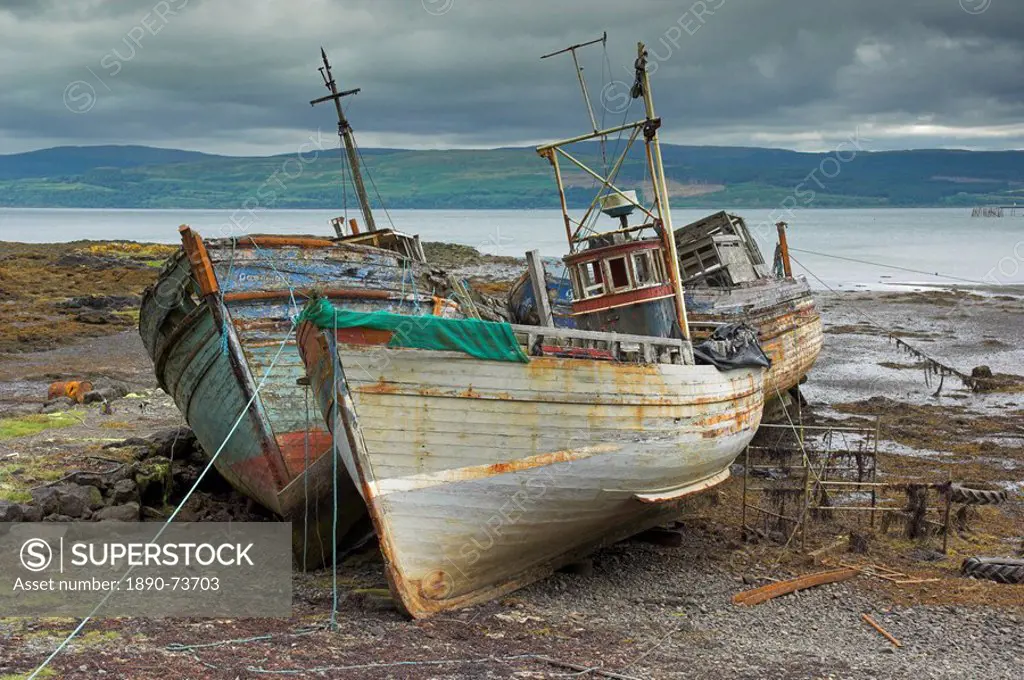 Wrecked fishing boats in gathering storm, Salen, Isle of Mull, Inner Hebrides, Scotland, United Kingdom, Europe