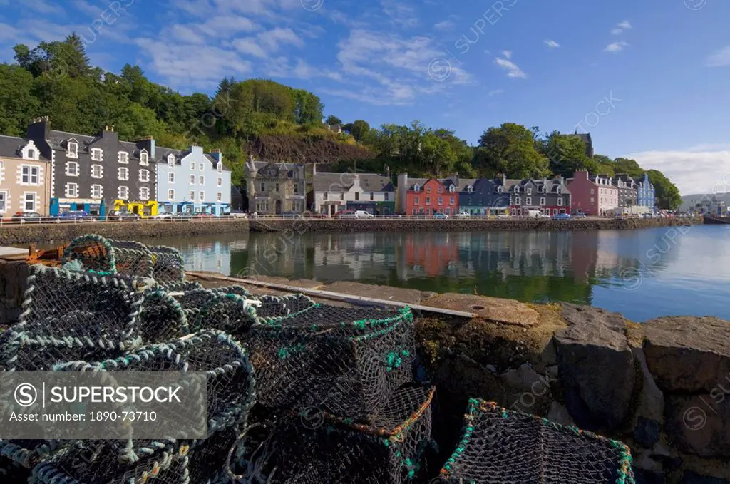 Multicoloured houses, and lobster pots on the jetty, in the harbour at Tobermory, Balamory, Mull, Inner Hebrides, Scotland, United Kingdom, Europe