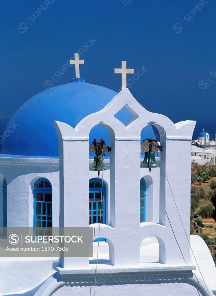 Close_up of white walls and bells in bell tower with blue dome behind at a church in Apollonia, on Sifnos, Cyclades, Greek Islands, Greece, Europe